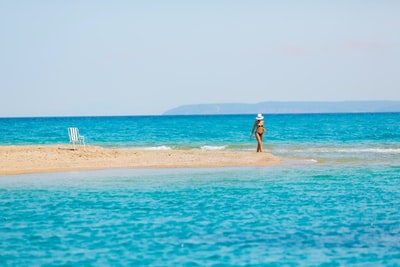 The woman stood on the sand during the day
